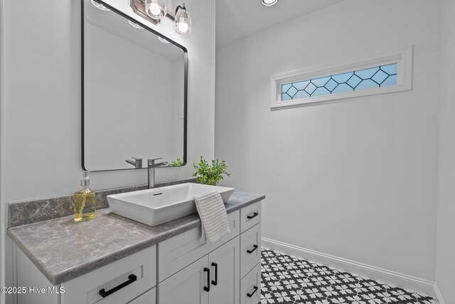 bathroom with tile patterned floors, baseboards, and vanity