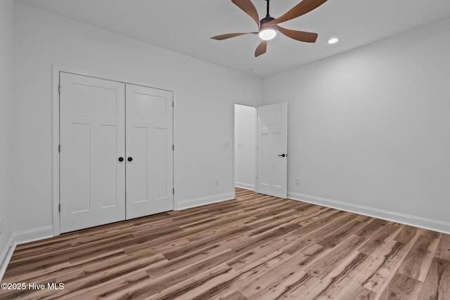 unfurnished bedroom featuring wood finished floors, baseboards, recessed lighting, a closet, and ceiling fan