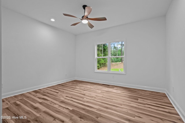 unfurnished room with wood finished floors, a ceiling fan, baseboards, and recessed lighting