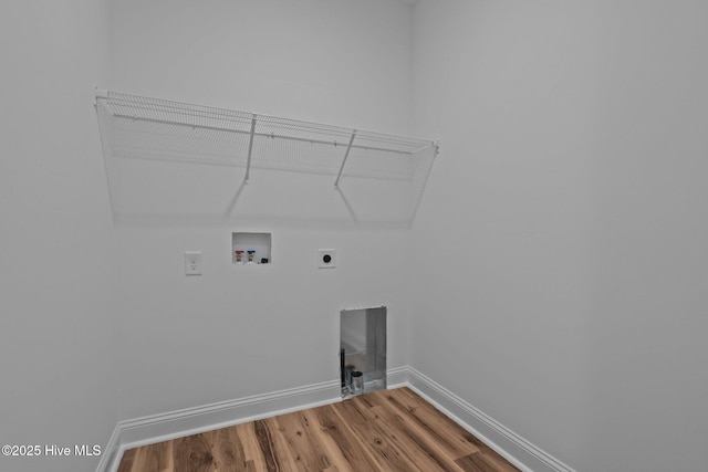 laundry room with electric dryer hookup, washer hookup, wood finished floors, and baseboards