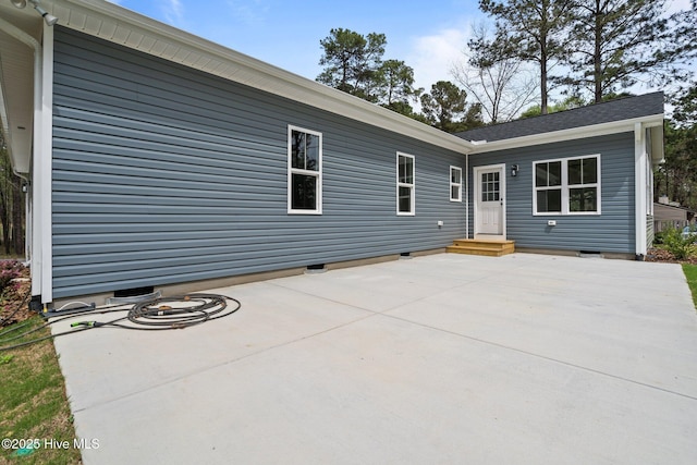 rear view of house with crawl space and a patio area