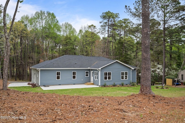 back of property with a patio, crawl space, a yard, and a shingled roof