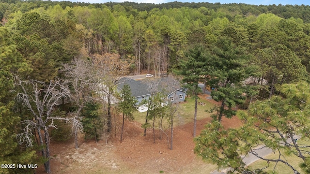 view of subject property featuring a forest