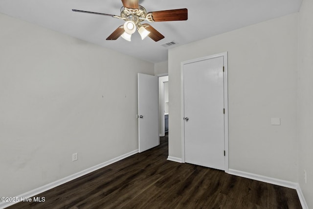 208 E Lakeridge Lndg, Jacksonville, NC 28546 - unfurnished bedroom featuring dark wood-style flooring, baseboards, and ceiling fan