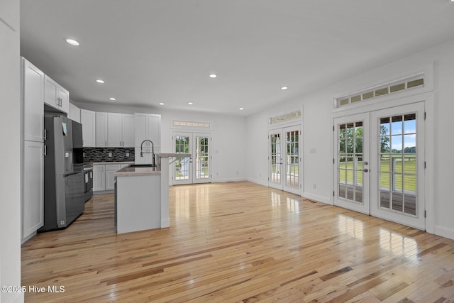 2142 Raccoon Rd, Willard, NC 28478 - kitchen with french doors, stainless steel refrigerator with ice dispenser, healthy amount of natural light, light wood-type flooring, and recessed lighting