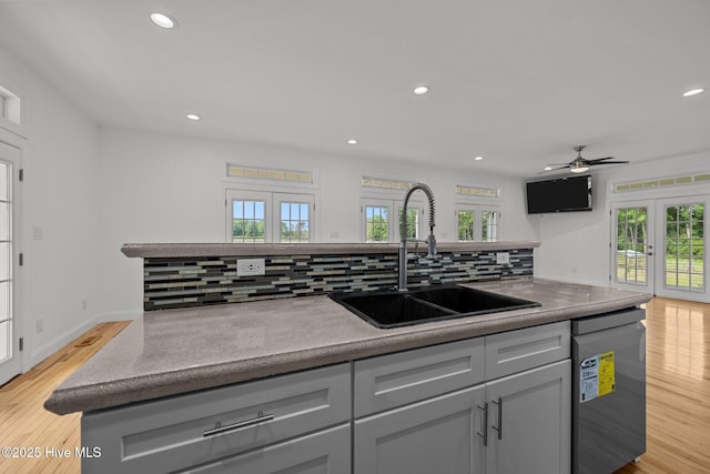 2142 Raccoon Rd, Willard, NC 28478 - kitchen with a sink, stainless steel dishwasher, french doors, gray cabinetry, and backsplash