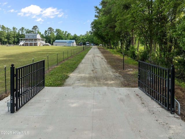 2142 Raccoon Rd, Willard, NC 28478 - view of dirt / gravel driveway with a gate and a gated entry
