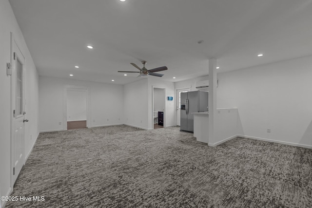 2142 Raccoon Rd, Willard, NC 28478 - empty room with light colored carpet, recessed lighting, an AC wall unit, a ceiling fan, and baseboards