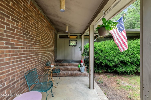 view of front of house with brick siding, asphalt driveway, an attached garage, a chimney, and a front yard