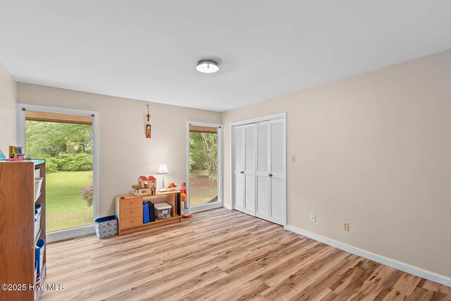 bedroom featuring wood finished floors and baseboards
