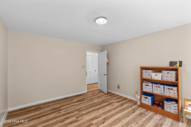 bedroom featuring wood finished floors and baseboards