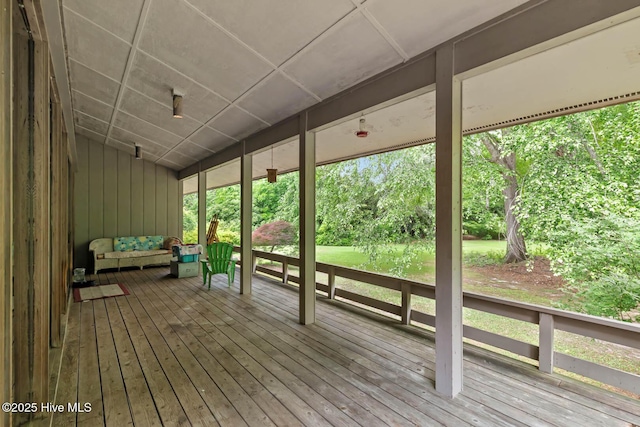wooden terrace with an outdoor living space