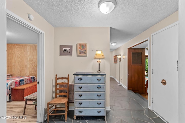 entrance foyer with a textured ceiling and baseboards