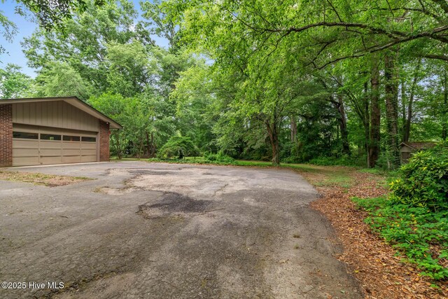 garage with asphalt driveway