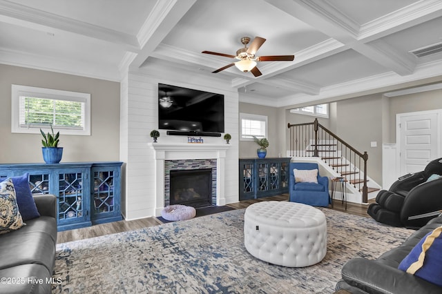 living room featuring crown molding, coffered ceiling, stairs, wood finished floors, and a ceiling fan