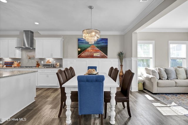 dining space featuring a chandelier, dark wood-style floors, crown molding, and recessed lighting