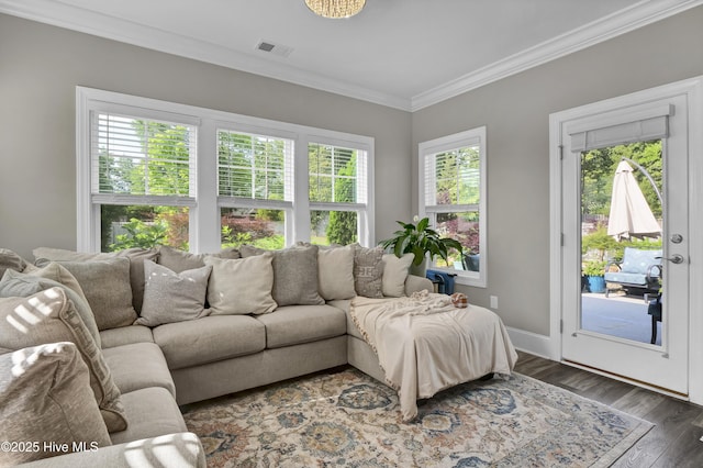 living room featuring crown molding, wood finished floors, and baseboards