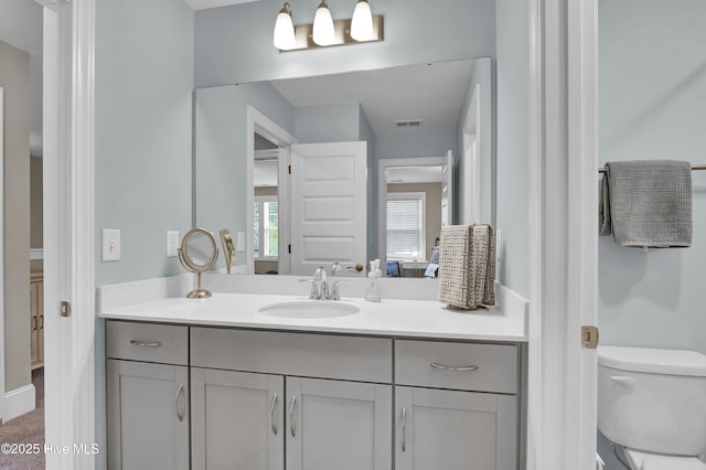 bathroom featuring vanity and toilet