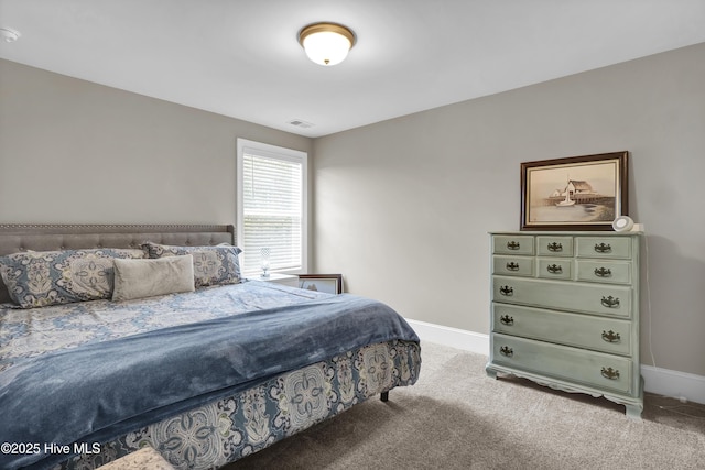 bedroom with carpet floors and baseboards