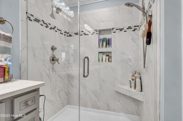 full bathroom with a marble finish shower and vanity