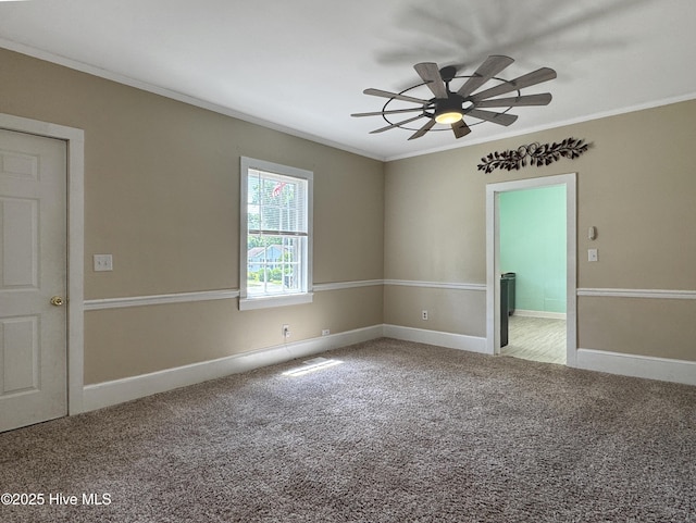 402 Warren St, Williamston, NC 27892 - spare room with crown molding, carpet floors, a ceiling fan, and baseboards