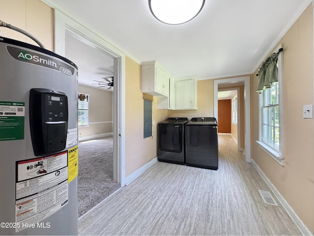 402 Warren St, Williamston, NC 27892 - clothes washing area with electric water heater, washer and dryer, light wood-style flooring, cabinet space, and baseboards