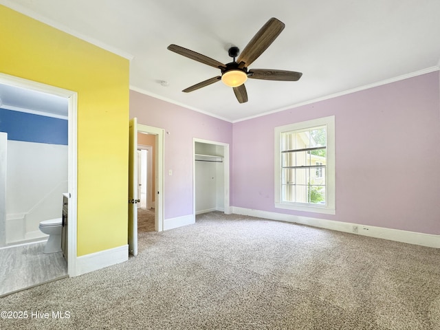 402 Warren St, Williamston, NC 27892 - unfurnished bedroom with ornamental molding, carpet floors, baseboards, ensuite bath, and ceiling fan