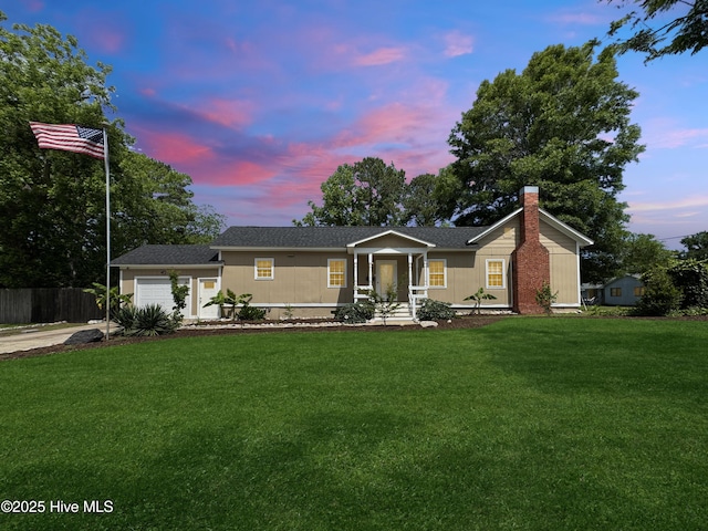 402 Warren St, Williamston, NC 27892 - view of front of property with a chimney, a garage, and concrete driveway
