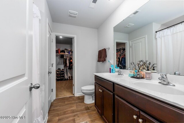 308 Isabelle St Lot # 986, New Bern, NC 28560 - full bathroom featuring toilet, a spacious closet, double vanity, and wood finished floors