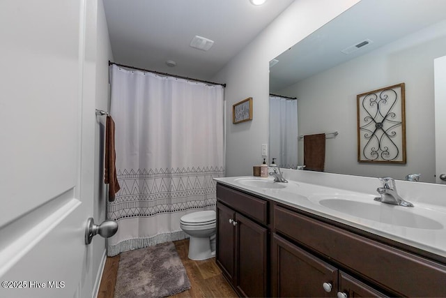 308 Isabelle St Lot # 986, New Bern, NC 28560 - bathroom featuring wood finished floors, toilet, double vanity, and curtained shower