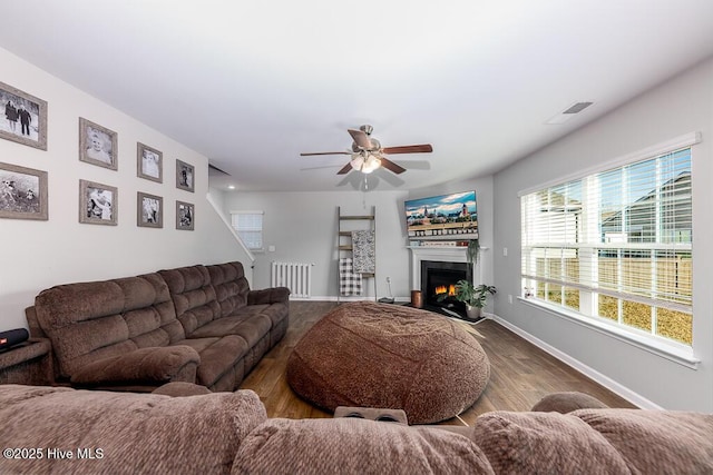 308 Isabelle St Lot # 986, New Bern, NC 28560 - living room with baseboards, wood finished floors, a ceiling fan, and a lit fireplace