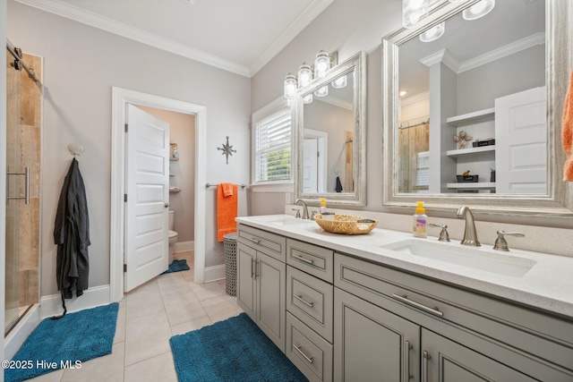 152 NW 1st St, Oak Island, NC 28465 - bathroom with double vanity, a stall shower, toilet, tile patterned floors, and crown molding