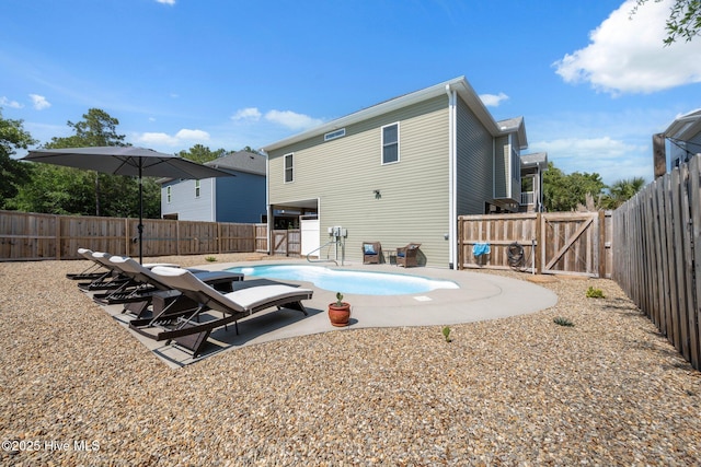 152 NW 1st St, Oak Island, NC 28465 - view of swimming pool with a gate, a fenced backyard, and a patio area