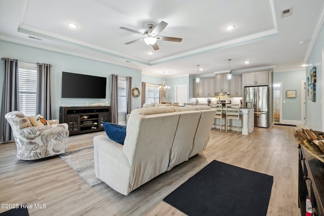 152 NW 1st St, Oak Island, NC 28465 - living area featuring a raised ceiling, a ceiling fan, crown molding, light wood-type flooring, and recessed lighting