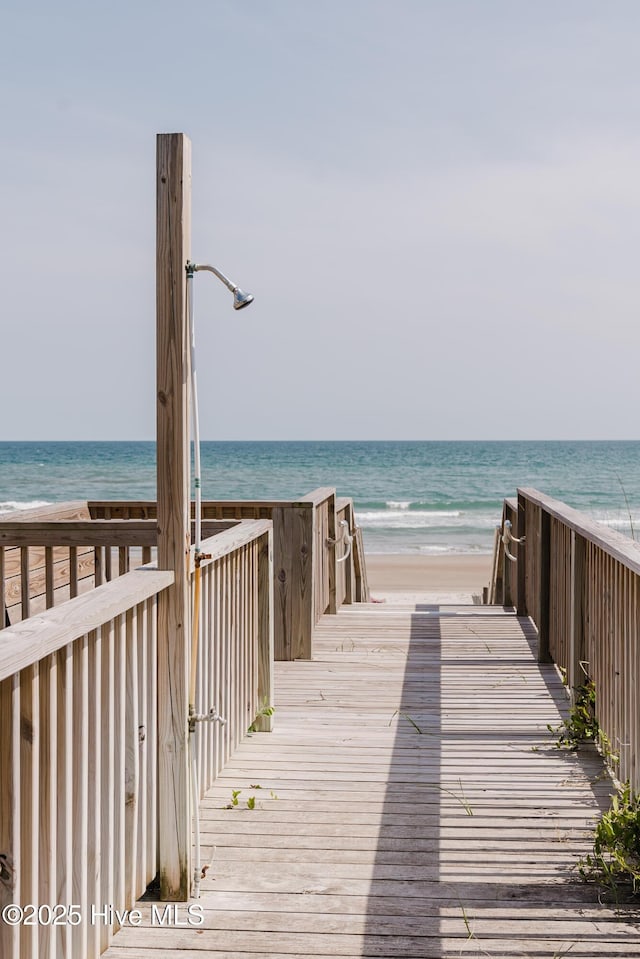 view of community with view of water and beach