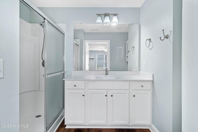 bathroom featuring a stall shower and vanity