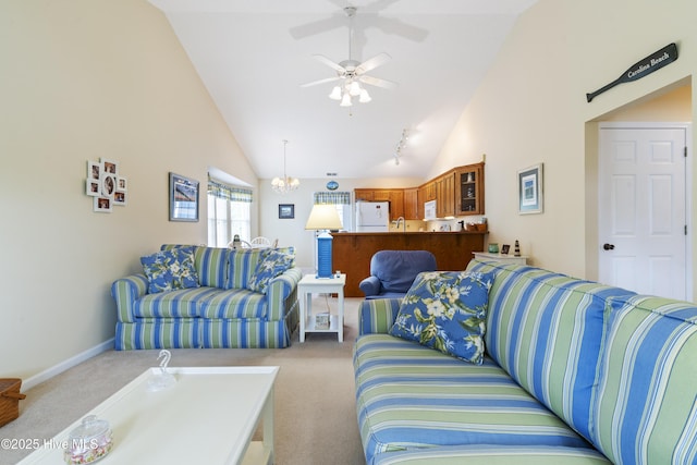living area featuring carpet, a ceiling fan, high vaulted ceiling, baseboards, and a chandelier