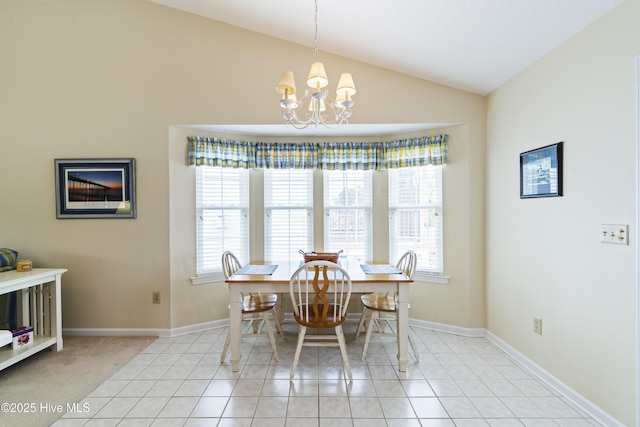 dining room featuring vaulted ceiling, a chandelier, light tile patterned floors, and baseboards