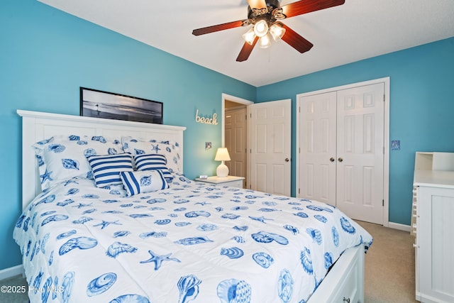bedroom with light carpet, a closet, baseboards, and ceiling fan