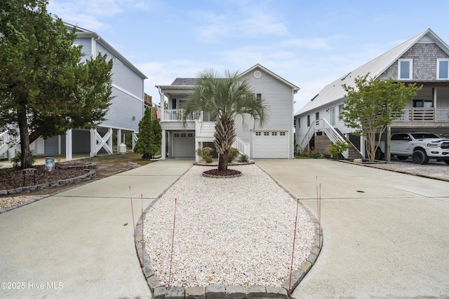 coastal home featuring concrete driveway and a garage