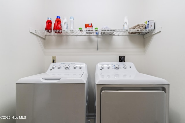 clothes washing area with washing machine and dryer