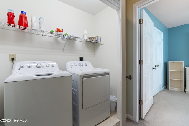 washroom with washer and clothes dryer, light colored carpet, and baseboards