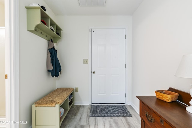 mudroom with light wood finished floors and baseboards