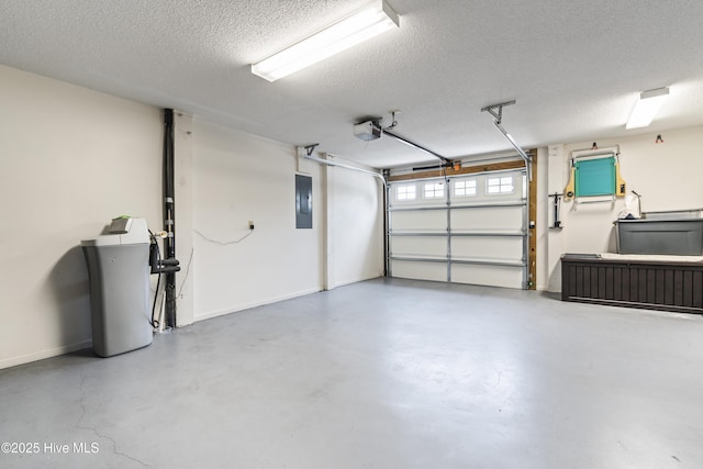 garage with electric panel, a garage door opener, and baseboards