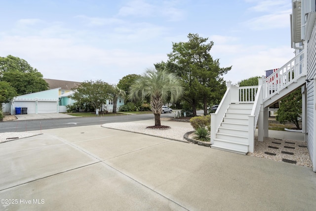view of yard featuring stairs and a garage