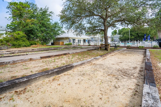 ranch-style house featuring fence
