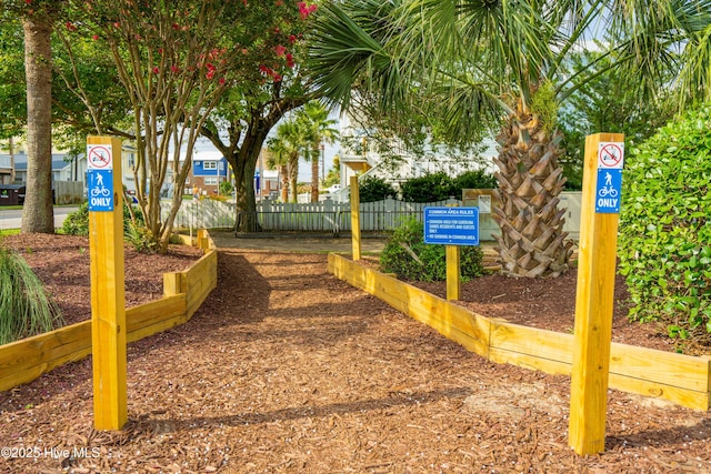 view of home's community featuring fence