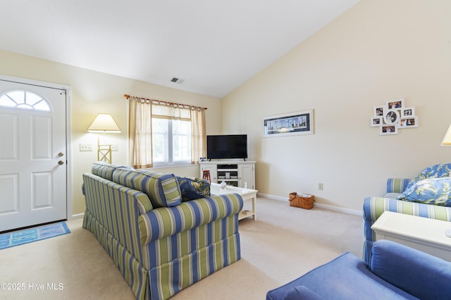 living room featuring carpet flooring, baseboards, and lofted ceiling