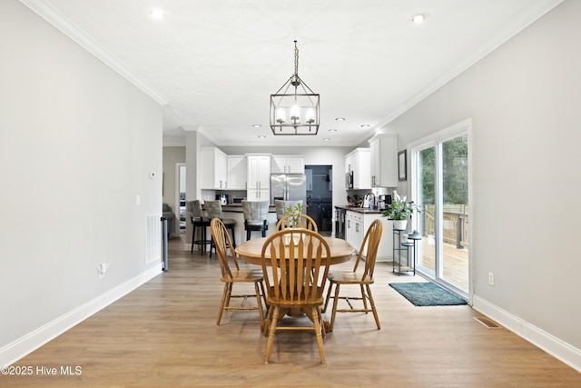 dining space with a chandelier, crown molding, light wood-type flooring, baseboards, and recessed lighting