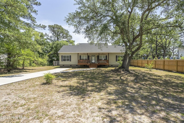 ranch-style house featuring crawl space, covered porch, fence, and concrete driveway